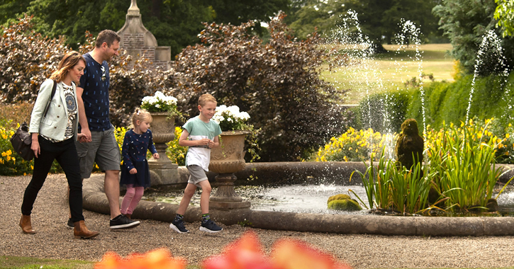 family walking through Raby Castle walled gardens